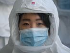 In this photo taken on March 12, 2020, medical workers wearing protective clothing against the COVID-19 novel coronavirus walk to a decontamination area at the Keimyung University hospital in Daegu. - South Korea -- once the largest coronavirus outbreak outside China -- saw its newly recovered patients exceed fresh infections for the first time on March 13, as it reported its lowest number of new cases for three weeks. (Photo by Ed JONES / AFP)