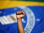 A demonstrator raises a fist during a protest against Brazil's President Jair Bolsonaro and racism, in Brasilia, Brazil, June 21, 2020. REUTERS/Adriano Machado