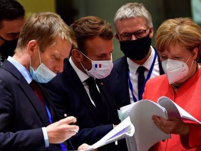 Na foto, o presidente do Governo espanhol, Pedro Sánchez (à esquerda), o presidente da França, Emmanuel Macron, e a chanceler alemã, Angela Merkel, examinam documentos durante a cúpula da UE em Bruxelas, nesta segunda-feira.