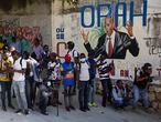 Journalists gather near a mural featuring Haitian President Jovenel Moise, near the leader’s residence where he was killed by gunmen in the early morning hours, and his wife was wounded, in Port-au-Prince, Haiti, Wednesday, July 7, 2021. Claude Joseph, the interim prime minister, confirmed the killing and said the police and military were in control of security in Haiti. (AP Photo/Joseph Odelyn)
