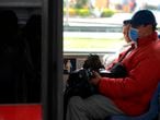 A passenger uses a mask at a bus station, as a preventive measure in the face of the global COVID-19 coronavirus pandemic, in Bogota on March 13, 2020. - Colombia declared on March 12, 2020 a "Health Emergency" due to the new coronavirus pandemic, a figure that allows it to take exceptional measures such as prohibiting the disembarkation of cruise ships and the holding of public events with more than 500 attendees. (Photo by Raul ARBOLEDA / AFP)