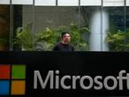 A man stands watch outside the Microsoft office building in Beijing, Tuesday, July 20, 2021. The Biden administration and Western allies formally blamed China on Monday for a massive hack of Microsoft Exchange email server software and asserted that criminal hackers associated with the Chinese government have carried out ransomware and other illicit cyber operations. (AP Photo/Andy Wong)