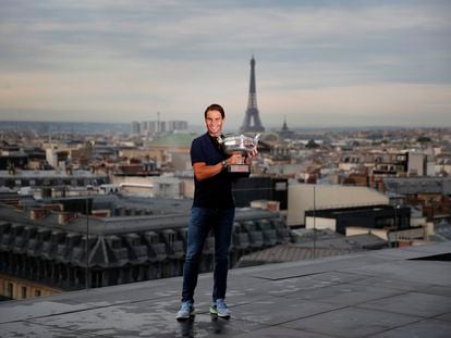 Spain's Rafael Nadal poses with his trophy during a photo call on the rooftop of Galeries Lafayette, Monday, Oct. 12, 2020, after winning Sunday the final match of the French Open tennis tournament against Serbia's Novak Djokovic in three sets, 6-0, 6-2, 7-5 at the Roland Garros stadium. (AP Photo/Francois Mori)