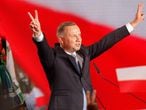 Polish President Andrzej Duda flashes V-signs after addressing supporters as exit poll results were announced during the presidential election in Lowicz, Poland, on June 28, 2020. - Poland's right-wing President Andrzej Duda topped round one of a presidential election on June 28, 2020, triggering a tight run-off with Warsaw's liberal Mayor Rafal Trzaskowski on July 12, according to an Ipsos exit poll. (Photo by Wojtek RADWANSKI / AFP)