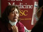 LOS ANGELES, CA - JANUARY 23, 2021 - Nidia Salas, 68, the daughter of Environmental Services Worker Marcos Salas, sticks out her tongue for nurse Natasha Buranasombati after she was feeling a bit dizzy after 
receiving her COVID-19 vaccine at Keck Medicine of USC in Los Angeles on January 23, 2021. Keck began vaccinating family members, who are 65 and older, of staff that included hospital housekeepers, valet and cafeteria workers. (Genaro Molina / Los Angeles Times via Getty Images)