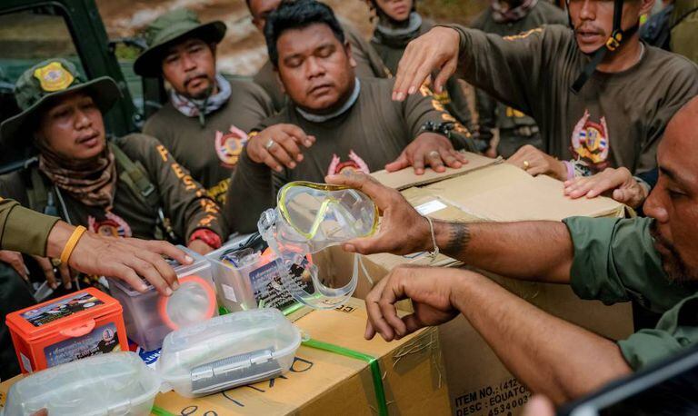 Responsáveis pelo resgate preparam óculos de mergulho para enviá-los aos meninos da gruta.