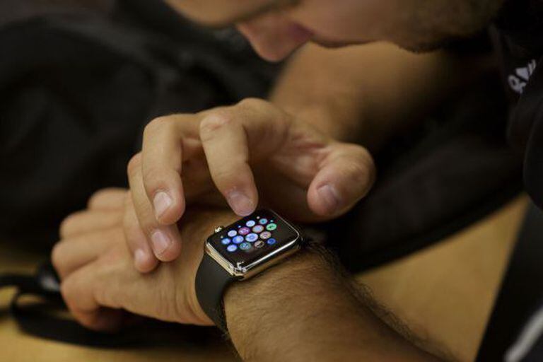 An employee sets up an Apple Watch for a customer at an Apple Inc. store, in New York, U.S., on Wednesday, June 17, 2015. Apple Inc. is rolling out a "Reserve & Pickup" system which allows customers to choose a Watch online then buy and collect the order in store. Photographer: Victor J. Blue/Bloomberg