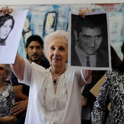 President of the Grandmothers of Plaza de Mayo human rights group, Estela de Carlotto, holds pictures of Maria del Carmen Moyano y Carlos Poblete, both disappeared during Argentina dictatorship in Buenos Aires, Argentina, Thursday, Dec. 28, 2017. The human rights group announced they have found the daughter of the couple, who was taken by the regime after Moyano gave birth to Polete's daughter while being a prisoner during the last military dictatorship in Argentina. (AP Photo/Natacha Pisarenko)