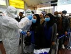 Iraqi medical staff check passengers' temperature, amid the new coronavirus outbreak, upon their arrival at Najaf airport, Iraq February 20, 2020. REUTERS/Alaa al-Marjani.