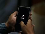 A man opens social media app 'Tik Tok' on his cell phone, in Islamabad, Pakistan, Tuesday, July 21, 2020. Pakistan has threatened the China-linked TikTok video service and blocked the Singapore-based Bigo Live streaming platform, citing what the regulating authority called widespread complaints about "immoral, obscene and vulgar" content. (AP Photo/Anjum Naveed)