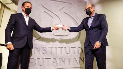 O governador João Doria e o diretor do Instituto Butantan, Dimas Covas, seguram uma dose da coronavac.