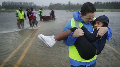 Voluntários resgatam crianças de sua casa inundada em James City, EUA