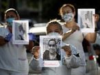 Healthcare workers wearing protective face masks pay tribute to their co-workers that have died from the coronavirus disease (COVID-19), amid the COVID-19 outbreak, and protest against the lack of personal protective equipment (PPE) in front of the 28 de Agosto hospital in Manaus, Brazil April 27, 2020. The signs read: "Miss you." REUTERS/Bruno Kelly
