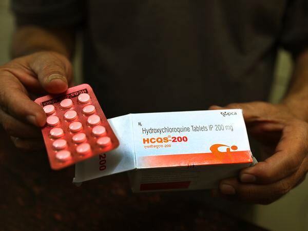 FILE - In this Thursday, April 9, 2020 file photo, a chemist displays hydroxychloroquine tablets in New Delhi, India. Scientists in Brazil have stopped part of a study of the malaria drug touted as a possible coronavirus treatment after heart rhythm problems developed in one-quarter of people given the higher of two doses being tested. Chloroquine and a similar drug, hydroxychloroquine, have been pushed by President Donald Trump after some early tests suggested the drugs might curb coronavirus entering cells.  (AP Photo/Manish Swarup, File)