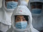In this photo taken on March 12, 2020, medical workers wearing protective clothing against the COVID-19 novel coronavirus walk to a decontamination area at the Keimyung University hospital in Daegu. - South Korea -- once the largest coronavirus outbreak outside China -- saw its newly recovered patients exceed fresh infections for the first time on March 13, as it reported its lowest number of new cases for three weeks. (Photo by Ed JONES / AFP)