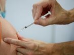 FILE PHOTO: A medical worker administers a dose of the Pfizer-BioNTech "Comirnaty" vaccine, as part of the coronavirus disease vaccination campaign, at the indoor Velodrome National of Saint-Quentin-en-Yvelines in Montigny-le-Bretonneux, southwest of Paris, France, August 13, 2021. REUTERS/Sarah Meyssonnier/File Photo