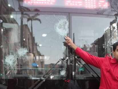Maduro mostra ônibus danificado pelos protestos.