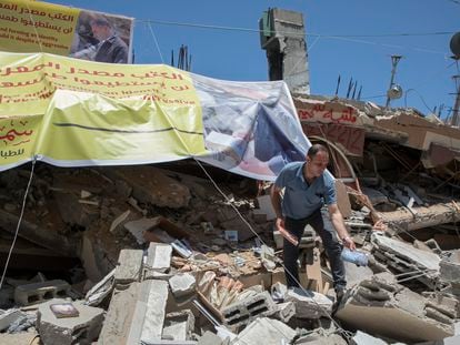 Um palestino resgata livros entre os escombros da livraria Mansur, destruída por um bombardeio israelense, em maio em Gaza.