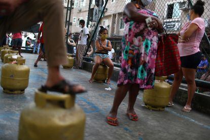 Moradores da Rocinha, no Rio de Janeiro, recebem botijões de gás doados pela Central Única das Favelas (Cufa), em 22 de maio, auge do fechamento das atividades no Brasil devido à pandemia.