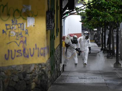 Trabalhadores sanitários desinfetam as ruas de Caracas, na Venezuela.