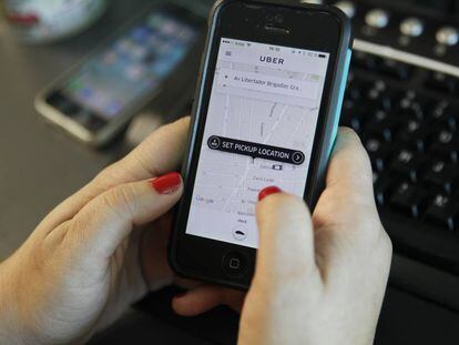 Uma pessoa pede um veículo através da aplicação móvel Uber.