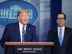 US President Donald Trump speaks as Treasury Secretary Steven Mnuchin listens during the daily briefing on the novel coronavirus, COVID-19, in the Brady Briefing Room of the White House in Washington, DC on April 21, 2020. (Photo by MANDEL NGAN / AFP)