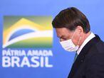 (FILES) In this file photo taken on June 01, 2021 Brazilian President Jair Bolsonaro attends the announcement of sponsorship of olympic sports team by the state bank Caixa Economica Federal at Planalto Palace, in Brasilia. - Brazilian President Jair Bolsonaro told a journalist to "shut up" during a press conference on June 21, 2021, and refered to the Globo Group, the country's largest media conglomerate, as "crap". (Photo by EVARISTO SA / AFP)