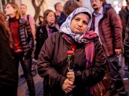 Uma mulher turca segura um cravo durante uma homenagem às vítimas do atentado de Paris na frente do consulado da França em Istambul.