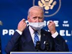 US President-elect Joe Biden removes his facemask before delivering remarks on the public health and economic crises at The Queen theater in Wilmington, Delaware on January 14, 2021. - President-elect Joe Biden will propose injecting $1.9 trillion into the US economy when he takes office next week, as evidence mounts that the recovery from the sharp downturn caused by Covid-19 is flagging. (Photo by JIM WATSON / AFP)